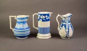 WILLIAM BROWNFIELD OR ATTRIBUTED TO, THREE NINETEENTH CENTURY RELIEF MOULDED POTTERY JUGS IN BLUE