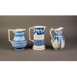 WILLIAM BROWNFIELD OR ATTRIBUTED TO, THREE NINETEENTH CENTURY RELIEF MOULDED POTTERY JUGS IN BLUE