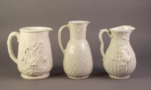 THREE UNATTRIBUTED NINETEENTH CENTURY WHITE GLAZED POTTERY JUGS RELIEF MOULDED WITH FLOWERS,