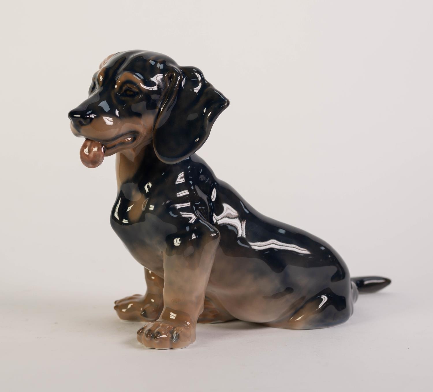 ROYAL COPENHAGEN PORCELAIN MODEL OF A DACHSHUND PUPPY, painted in natural tones and modelled
