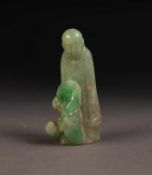 CHINESE SHADED PALE GREEN CARVED JADE FIGURE of a deity standing with a small animal at his feet,