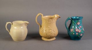 MINTONS OR ATTRIBUTED TO, THREE NINETEENTH CENTURY RELIEF MOULDED POTTERY JUGS, one buff glazed