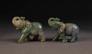 PAIR OF GREY CARVED JADE WELL-MODELLED ELEPHANTS each with trunk folded back over their heads, 1 7/