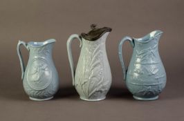 DUDSON OR ATTRIBUTED TO, THREE NINETEENTH CENTURY RELIEF MOULDED AND BLUE GLAZED POTTERY JUGS,