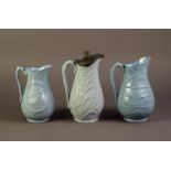 DUDSON OR ATTRIBUTED TO, THREE NINETEENTH CENTURY RELIEF MOULDED AND BLUE GLAZED POTTERY JUGS,