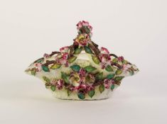 JOHN BEVINGTON FLORAL ENCRUSTED CHINA BASKET, of typical form, modelled with roses on a white