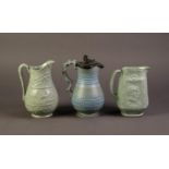 DUDSON OR ATTRIBUTED TO, THREE NINETEENTH CENTURY MOULDED AND GREEN GLAZED POTTERY JUGS, including a