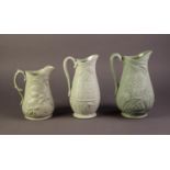 DUDSON OR ATTRIBUTED TO, THREE NINETEENTH CENTURY RELIEF MOULDED AND GREEN GLAZED POTTERY JUGS,