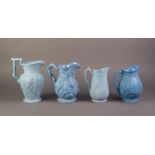 FOUR UNATTRIBUTED NINETEENTH CENTURY BLUE GLAZED AND RELIEF MOULDED POTTERY JUGS, comprising, one