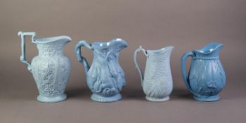 FOUR UNATTRIBUTED NINETEENTH CENTURY BLUE GLAZED AND RELIEF MOULDED POTTERY JUGS, comprising, one