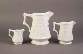 UNATTRIBUTED GRADUATED SET OF THREE WHITE GLAZED AND RELIEF MOULDED APOSTLE JUGS, the small with