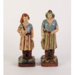 A PAIR OF LATE NINETEENTH CENTURY CONTINENTAL MAJOLICA FIGURES OF FISHERMEN, each carrying caught