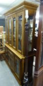 20TH CENTURY CONTINENTAL LIGHT WALNUT WOOD LARGE TWO-PART DISPLAY CABINET WITH CAVETTO CORNICE,