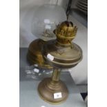 A LARGE BRASS OIL LAMP WITH GLASS SHADE AND FUNNEL AND A BRASS OIL TABLE LAMP WITH GLASS FUNNEL
