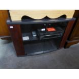 A BLACK FINISH CORNER TELEVISION STAND, THE CUPBOARD BASE ENCLOSED BY TWO PLATE GLASS FOLDING DOORS,