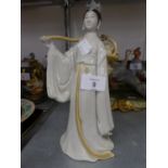 A PORCELAIN FIGURE OF A JAPANESE WOMAN WITH PANNIER BASKET