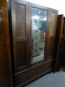 AN OAK WARDROBE WITH MIRROR DOOR (LACKING CORNICE)