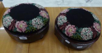 A PAIR OF VICTORIAN NEEDLEPOINT COVERED CIRCULAR FOOT STOOLS (2)