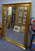 A LARGE GILT FRAMED BEVELLED EDGE WALL MIRROR (139cm high x 108cm wide) (frame a.f.)