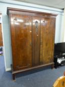 A CARVED MAHOGANY WARDROBE WITH TWO DOORS, ONE ENCLOSING FOUR TRAY SHELVES, 5? WIDE