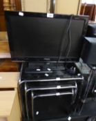 A POLAROID SMALL FLAT SCREEN TV, A NEST OF THREE TUBULAR METAL FRAMED COFFEE TABLES WITH BLACK GLASS