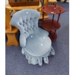 A MAHOGANY OFFICE CIRCULAR THREE TIER WHAT-NOT AND A BOUDOIR BUTTONED BACK EASY CHAIR, ON TURNED