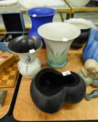 A HEAVY BLACK ART GLASS TREFOIL BOWL, 6? HIGH; TWO WHITE AND LEAF PAINTED POTTERY VASES AND A