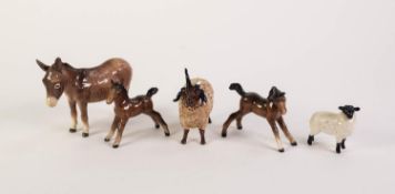 FOUR BESWICK POTTERY MODELS OF ANIMALS, comprising: DONKEY, TWO BROWN FOALS, one facing right, the