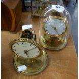 TWO KUNDO SMALL ANNIVERSARY CLOCKS ON CIRCULAR BASES, (ONE ONLY WITH GLASS DOME SHADE)