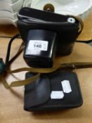 A PAIR OF 10 X 25 COMPACT BINOCULARS AND A ZENIT ? E SLR ROLL FILM CAMERA, IN CASE