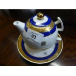 A MODERN 'HOUSE OF LORDS' TEAPOT AND CUP AND SAUCER, BLUE AND GOLD BANDED, EACH GILT WITH 'PALACE OF