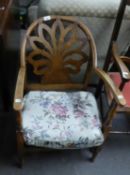 AN OAK LOW NURSING CHAIR, THE BACK HAVING FAN DESIGN