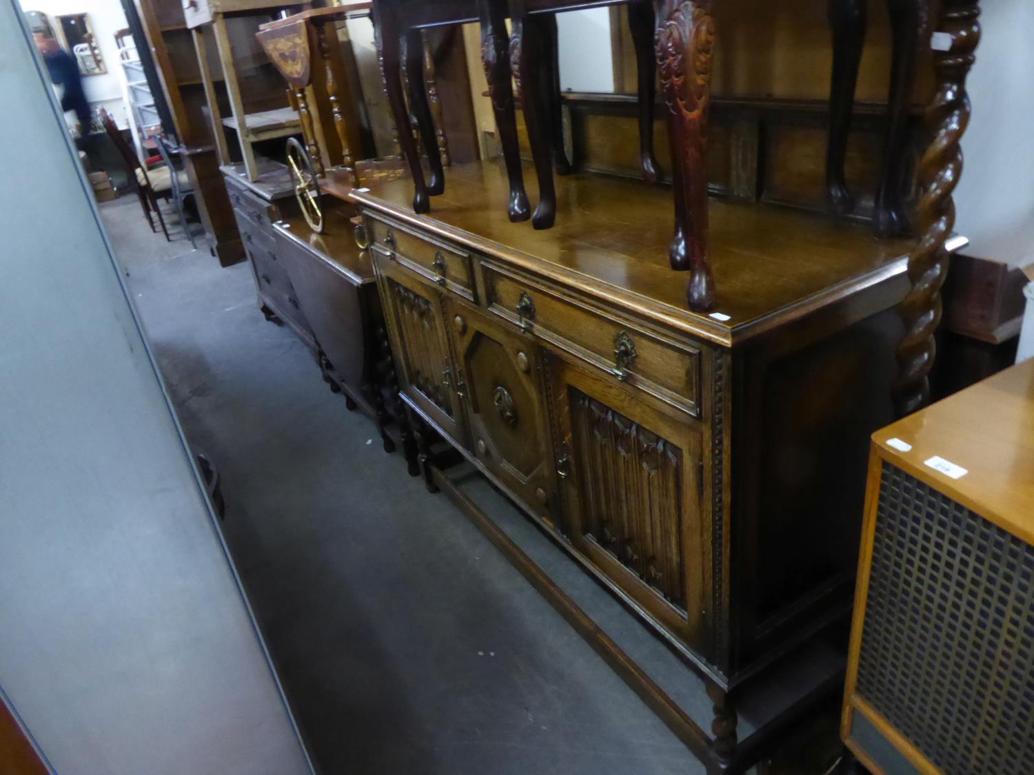 JACOBEAN STYLE CARVED OAK SIDEBOARD WITH LEDGE BACK, TWO DRAWERS OVER THREE DOORS, TWO WITH LINEN