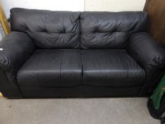 A BLACK HIDE TWO SEATER SETTEE