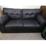 A BLACK HIDE TWO SEATER SETTEE