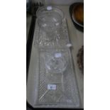 A CUT GLASS PEDESTAL DEEP BOWL (A.F.)  5 ¾? DIAMETER; TWO CUT GLASS DRESSING TABLE TRAYS; A POWDER