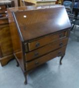 A MAHOGANY BUREAU WITH THREE LONG DRAWERS, ON CABRIOLE LEGS