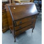 A MAHOGANY BUREAU WITH THREE LONG DRAWERS, ON CABRIOLE LEGS