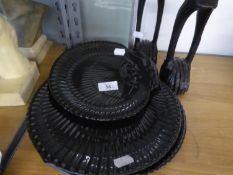 A SET OF THREE MODERN WEDGWOOD HIGH GLAZED BLACK BASALT GRADUATED SHELL SHAPED DISHES OR PLAQUES