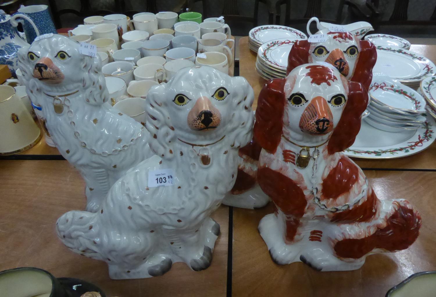 TWO PAIRS OF VICTORIAN POTTERY MANTLE DOGS, typically modelled, one pair with gilt splashed coats,
