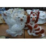 TWO PAIRS OF VICTORIAN POTTERY MANTLE DOGS, typically modelled, one pair with gilt splashed coats,