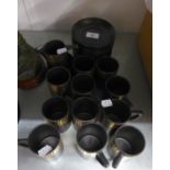 TWENTY SEVEN PIECE STYLISH BLACK AND GILT POTTERY PART COFFEE SET, comprising: ELEVEN CUP and