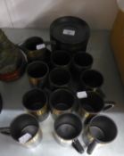 TWENTY SEVEN PIECE STYLISH BLACK AND GILT POTTERY PART COFFEE SET, comprising: ELEVEN CUP and