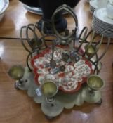 EARLY TWENTIETH CENTURY ELECTROPLATED SIX PERSON EGG CRUET, with moulded pottery plate and toast