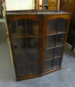 AN OAK BOOKCASE, HAVING TWO EIGHT PANEL GLASS DOORS, INTERIOR  HAVING ADJUSTABLE SHELVES