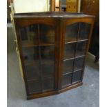 AN OAK BOOKCASE, HAVING TWO EIGHT PANEL GLASS DOORS, INTERIOR  HAVING ADJUSTABLE SHELVES