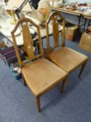 A PAIR OF WALNUT DINING CHAIRS, WITH ARCH TOPS, SCROLL CARVED SPLATS, DROP-IN SEATS, ON SQUARE