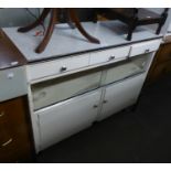 A WHITE PAINTED WOOD KITCHEN CABINET WITH FORMICA TOP, ON TV LEGS, CIRCA 1950'S
