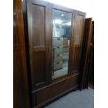 AN OAK WARDROBE WITH MIRROR DOOR (LACKING CORNICE)