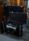 LG FLAT SCREEN TELEVISION, 25?, ON BLACK GLASS THREE-TIER STAND WITH SANYO VIDEO RECORDER AND